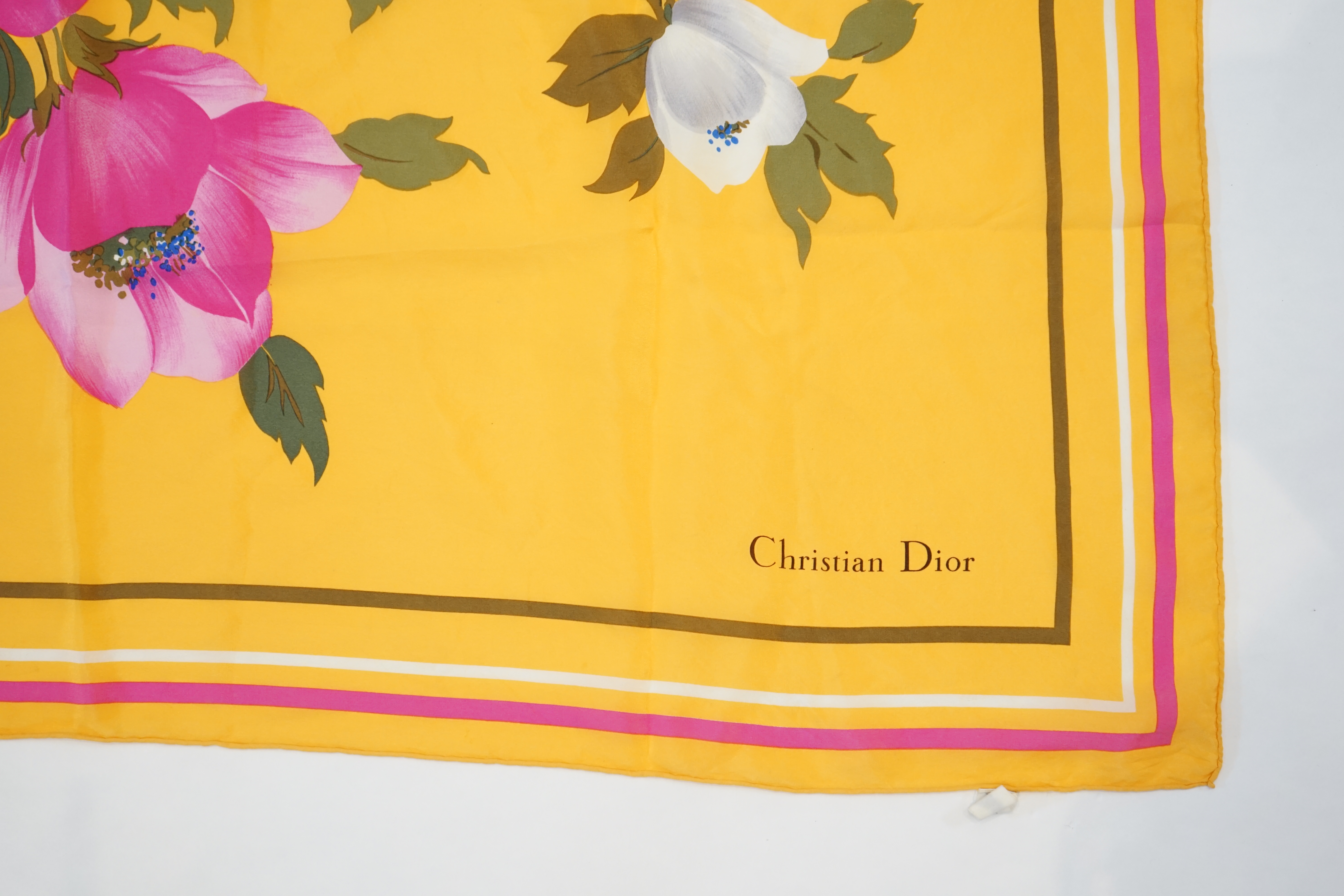 A Bvlgari by Davide Pizzigoni silk scarf, a yellow floral Christian Dior silk scarf and a Moschino Cheap and Chic chiffon scarf